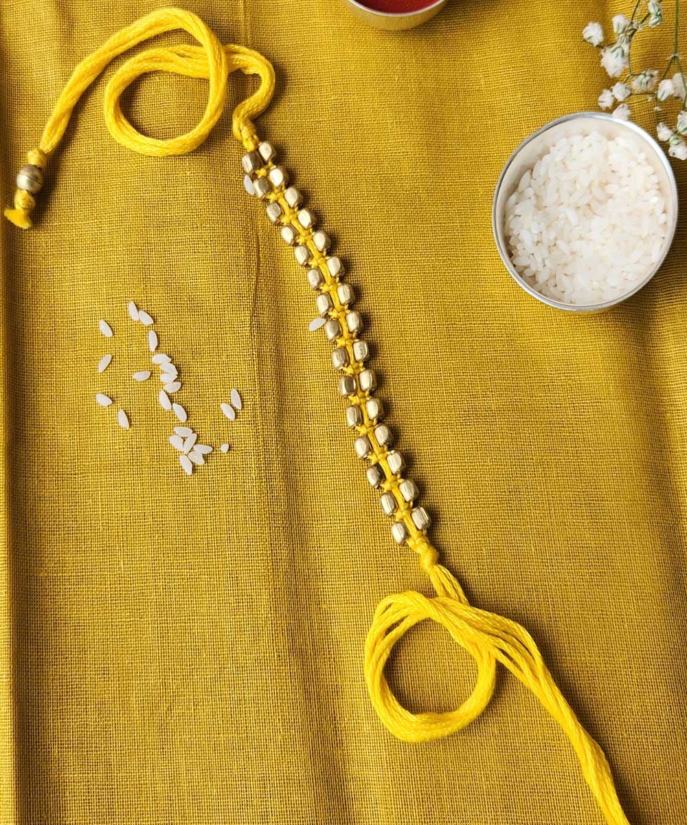 Handcrafted yellow beaded mercerised cotton rakhi
