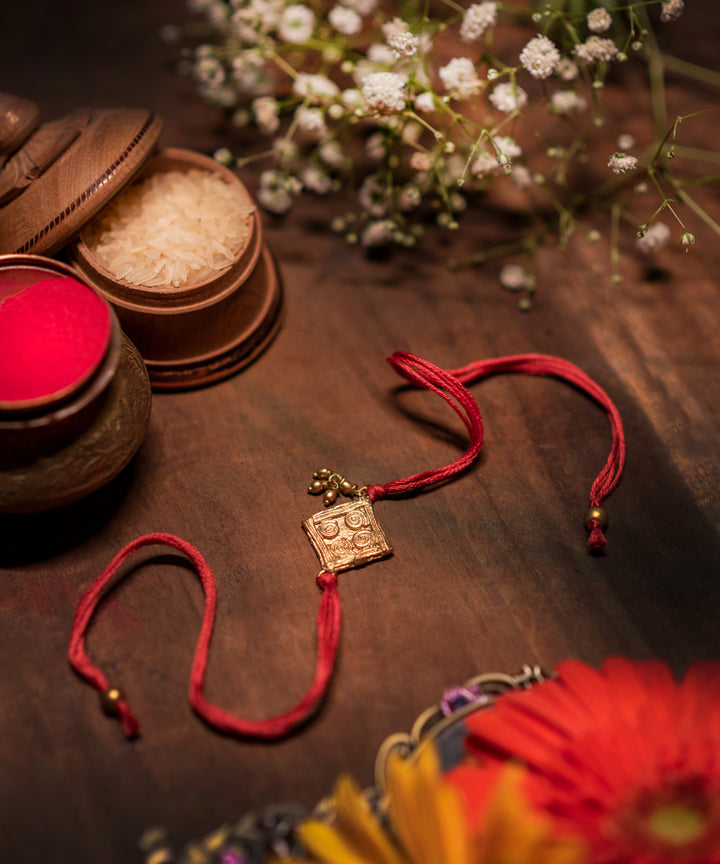 Handcrafted dokhra rakhi with red mercerised cotton thread
