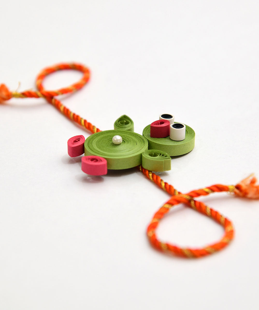 Green handcrafted paper quilling rakhi